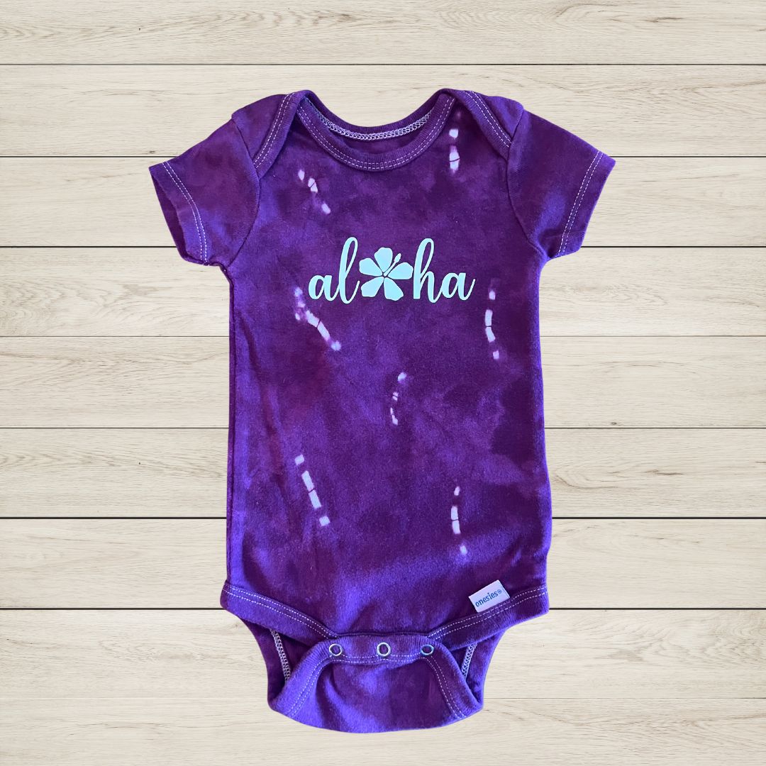 'Aloha' with flower baby onesie in purple