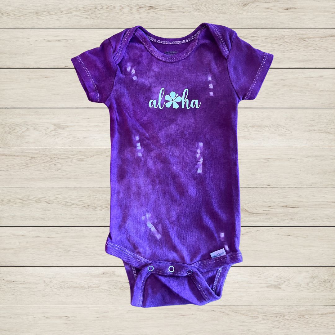 'Aloha' with flower baby onesie in purple